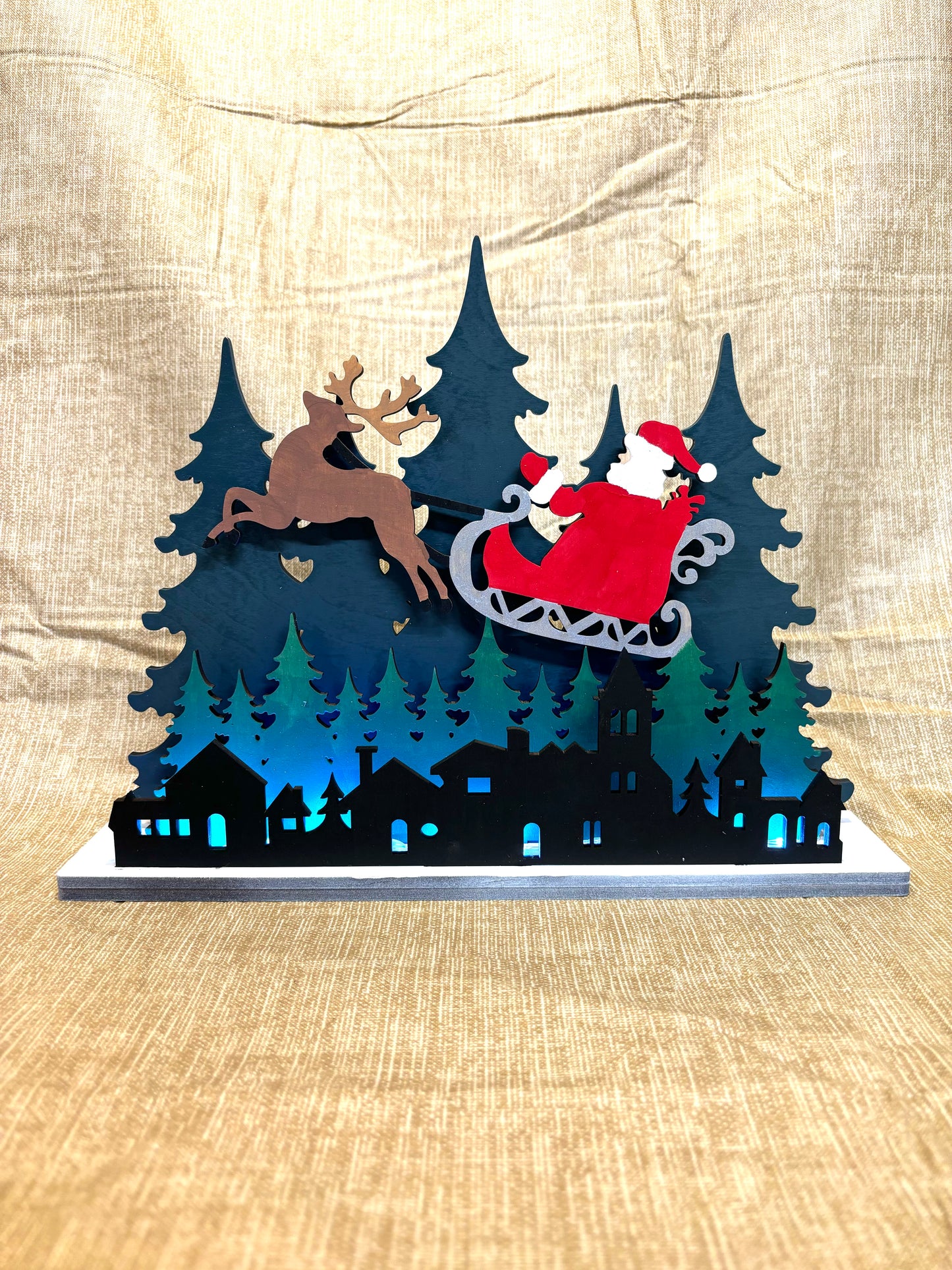 Santa over the city lighted shelf sitter