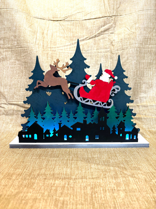 Santa over the city lighted shelf sitter